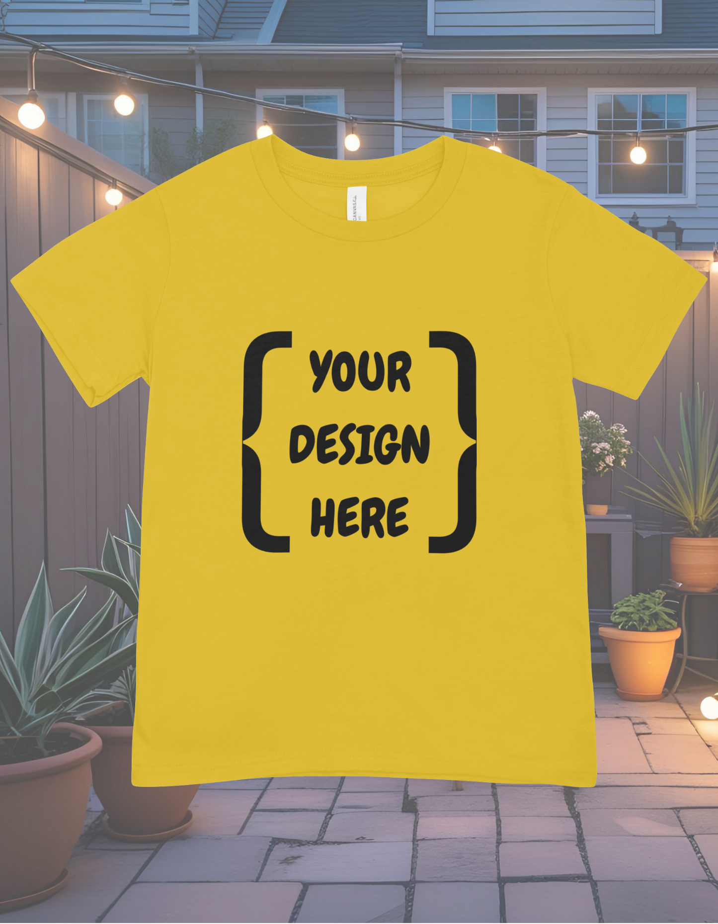 Yellow t-shirt with 'Your Design Here' text on a string of lights and house background